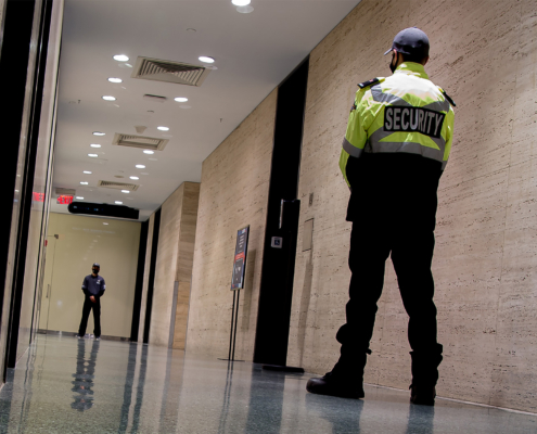 Low angle shot of security guards patrolling inside commercial building