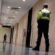 Low angle shot of security guards patrolling inside commercial building