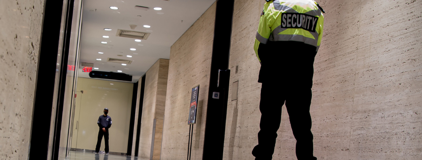 Low angle shot of security guards patrolling inside commercial building
