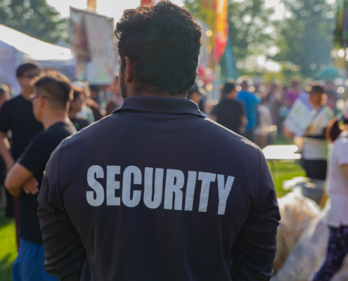 A security guard is controlling the traffic and parking situation