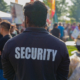 A security guard is controlling the traffic and parking situation