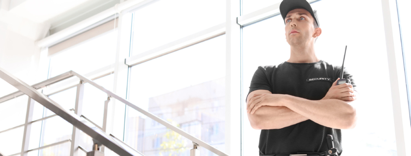 Male security guard with portable radio transmitter indoors
