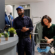 retail security officer wearing uniform standing at clothes shop